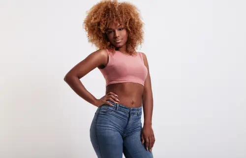 Smiling African woman posing for Tummy Tuck & Liposuction